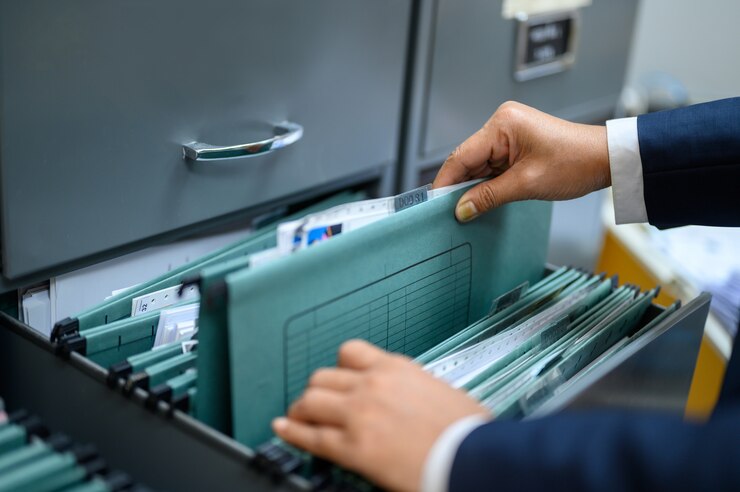 Employees are managing documents at the office.
