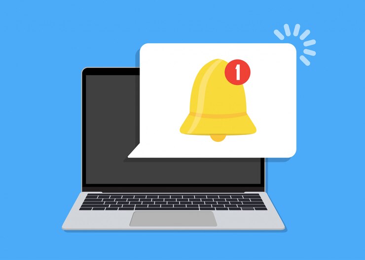 Laptop with bell notification speech bubble in a flat design